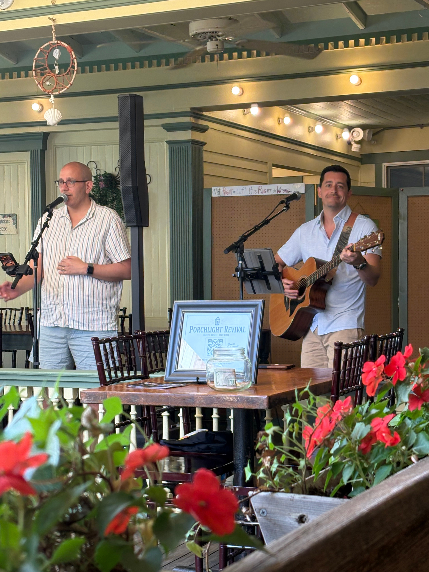 Porchlight Revival acoustic duo performing on a porch